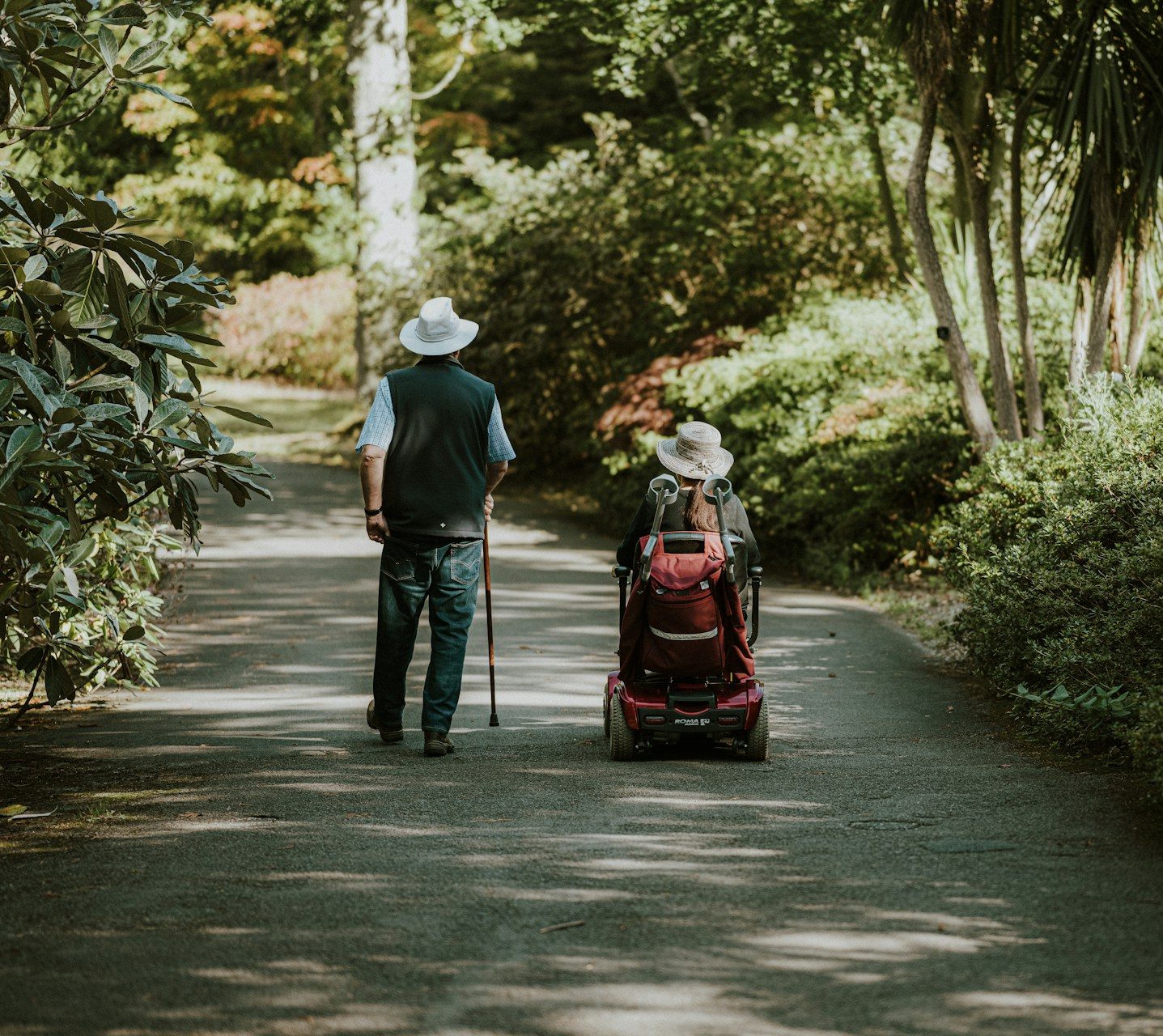a-man-and-a-woman-walking-down-a-dirt-road