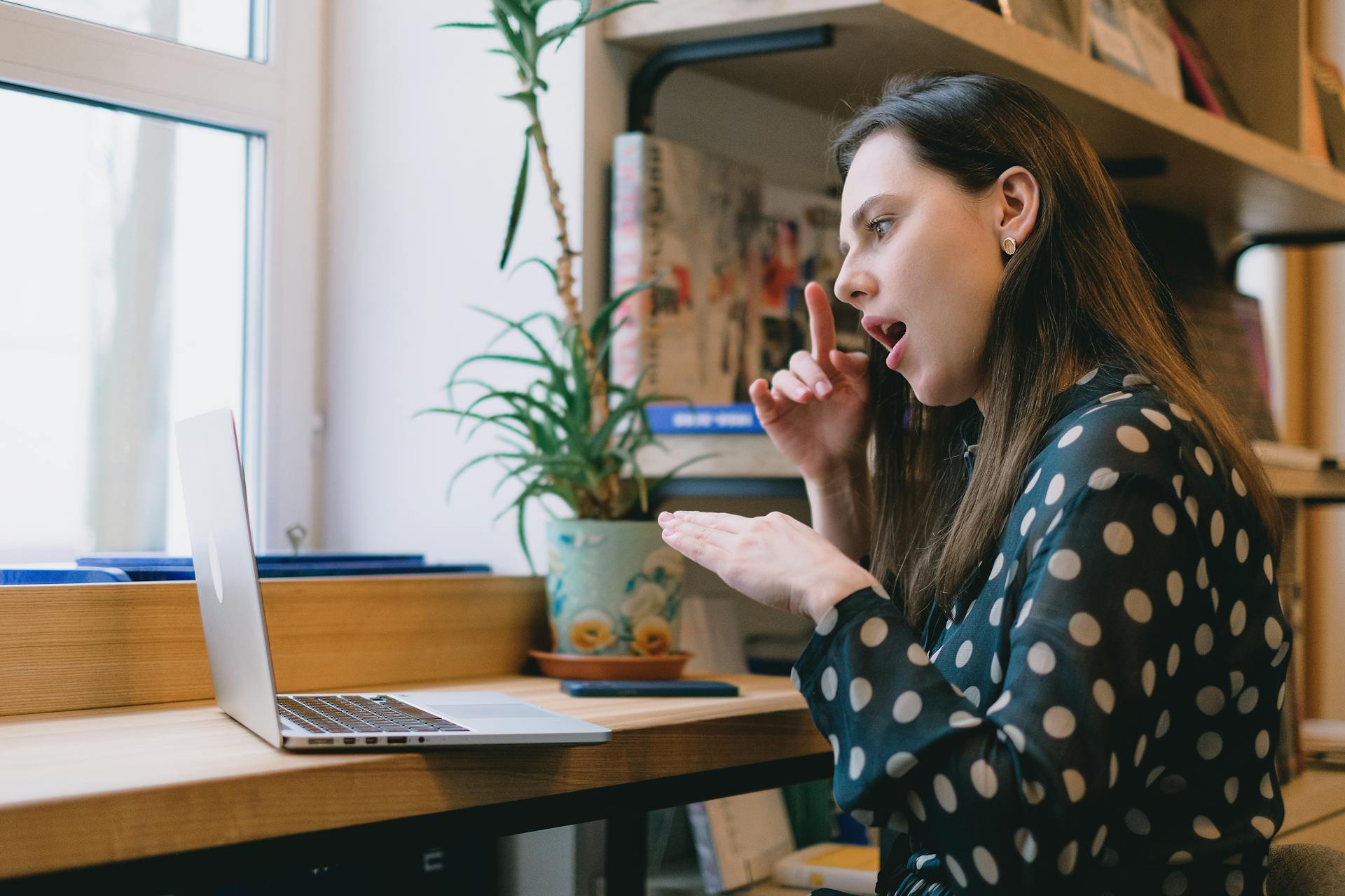young-female-student-learning-sign-language-during-online-lesson